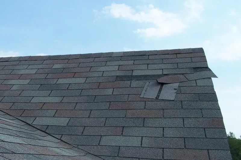 Roof with missing shingles.